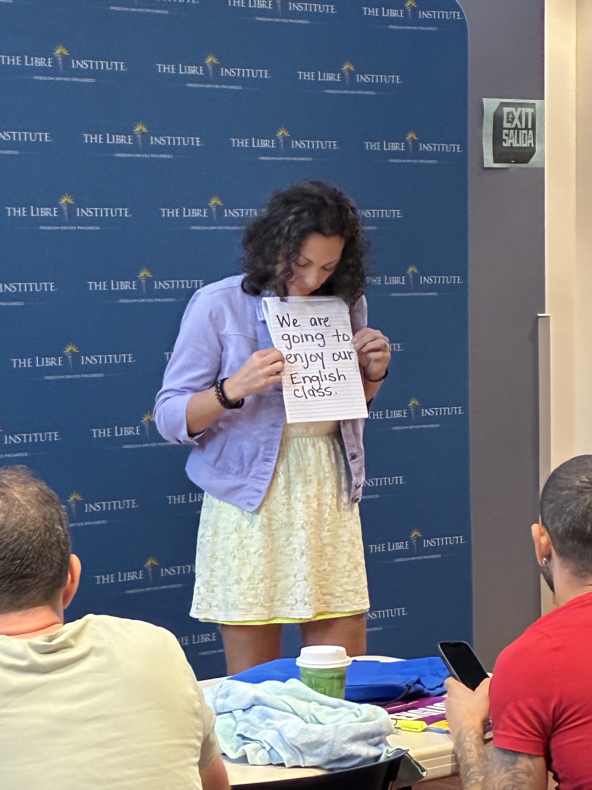 teacher holding educational sign